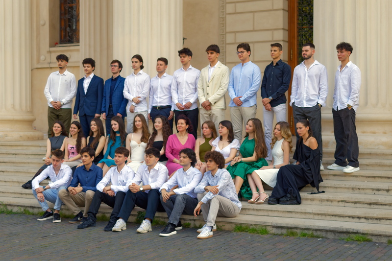3 - A high school graduation class group photo taken on the steps of a building